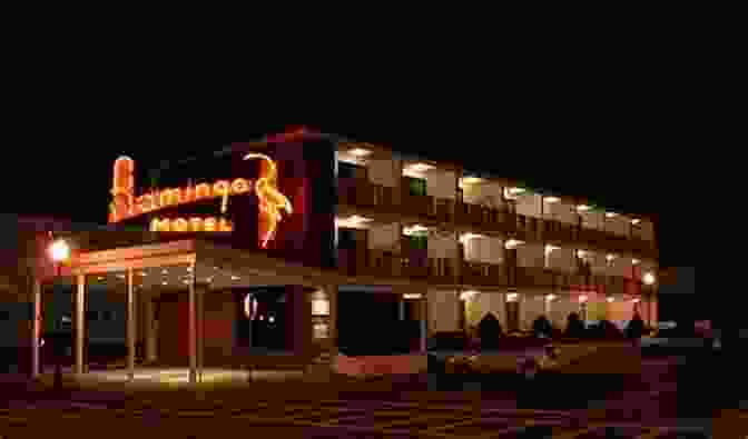 A Stunning Nighttime View Of The Motel, Its Facade Illuminated By Warm Lights, Casting A Magical Glow On The Surrounding Streets The Motel Ecrivain De Nuit